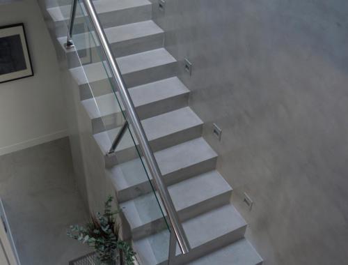 Escalera principal de una vivienda realizada bajo la novedosa técnica de microcemento. 