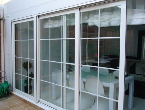 Ventana corredera de aluminio tres carriles con barrotillo.